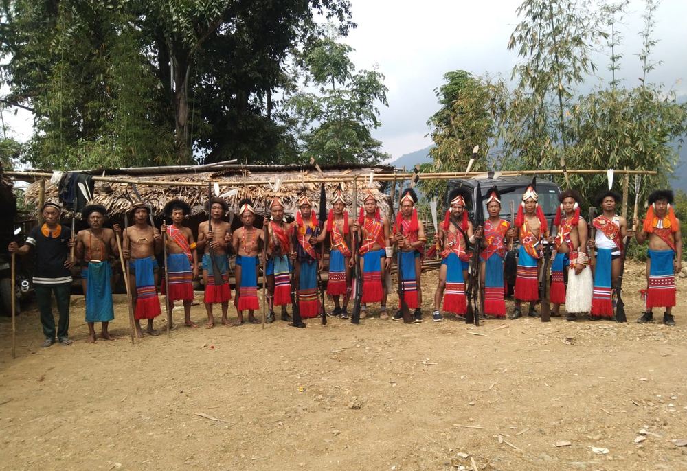 A line of Wancho men in traditional dress