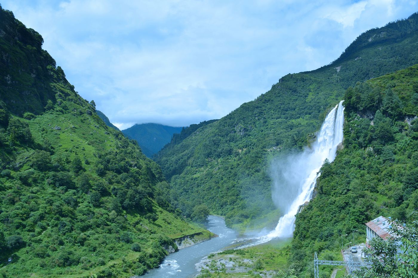 Nuranang waterfall falling into a green valley